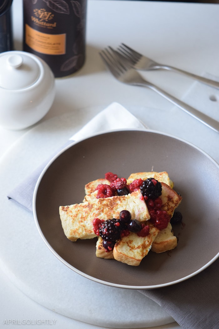 Easy French Toast Sticks recipe perfect for breakfast or brunch made with fresh fruit like raspberries, blueberries, and blackberries with maple syrup on top 