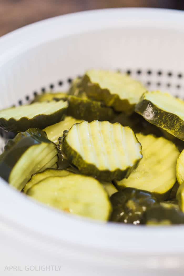 Pickle slices in a strainer