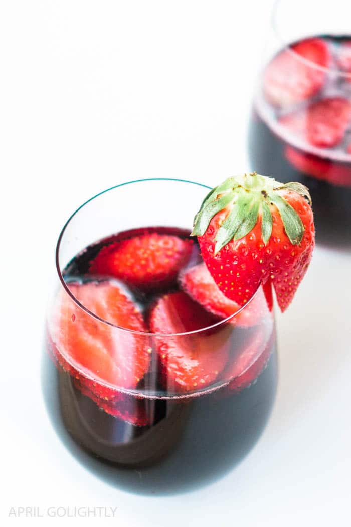 Super Easy Strawberry Red Wine Cocktail Recipe with 3 ingredients cabernet red wine, 2 strawberries thinly sliced, and garnish a strawberry