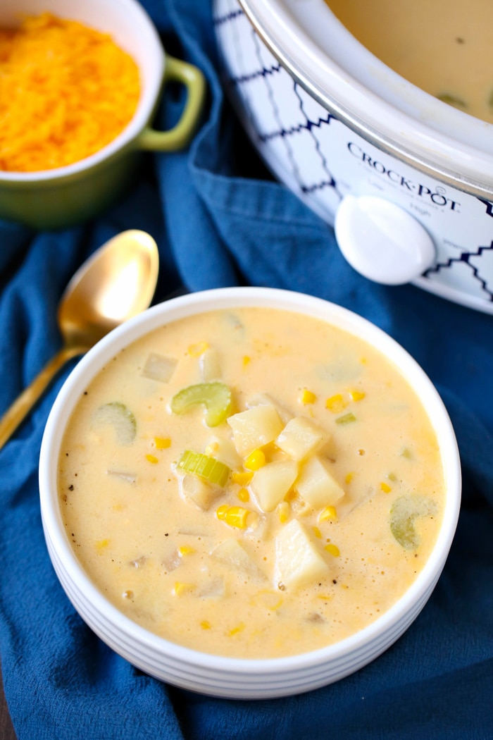 Easy Slow Cooker Potato Soup Recipe made in the crockpot with russet potatoes, vegetable broth, cheese, and topping ideas bacon, green onions, and olives