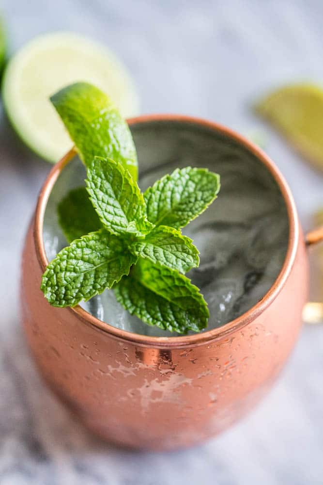 Easy Moscow Mule Cocktail Recipe made in the traditional copper mug made with vodka, fresh lime juice, Ginger Beer, a spring of mint and slice of lime 