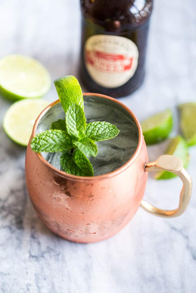 Easy Moscow Mule Cocktail Recipe made in the traditional copper mug made with vodka, fresh lime juice, Ginger Beer, a spring of mint and slice of lime 