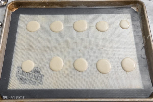 Vanilla Macarons on a silicone mat 